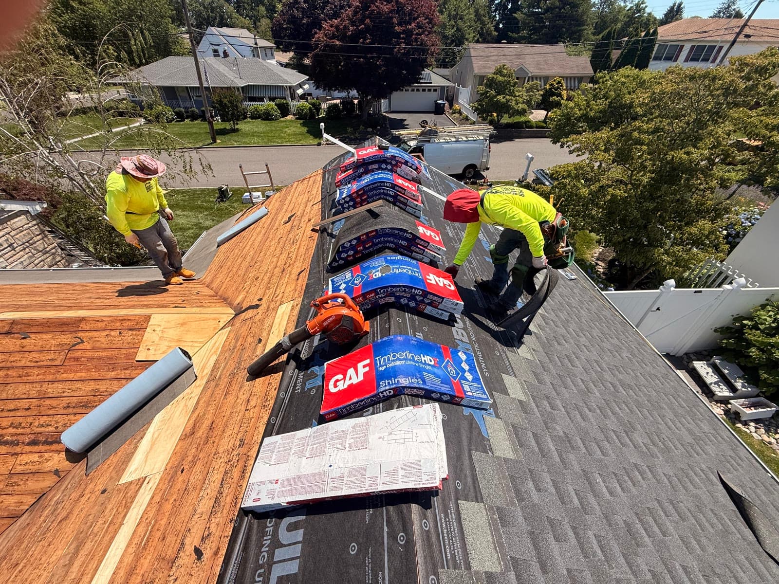 A Green Apple Roofing crew installing GAF shingles on a New Jersey home